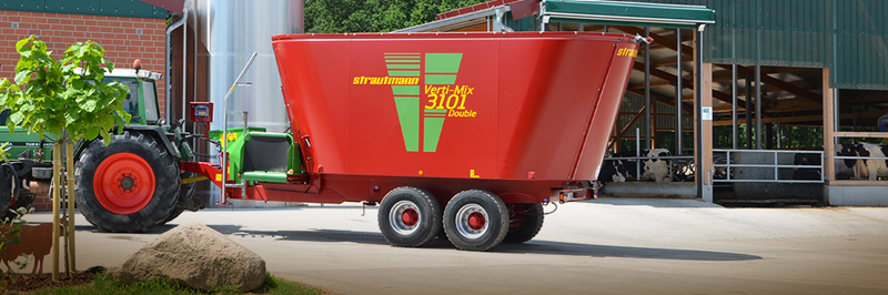 Strautmann Diet Feeder in yard with farmyard sheds in background