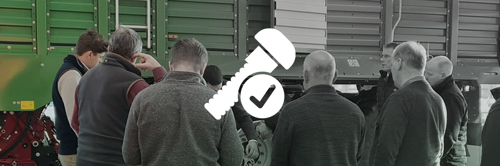 Icon of nut and bolt on image of customers and dealers looking at Strautmann Forage Wagon