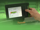 Image of operator using Smart 570 control panel on Strautmann Forage Wagon