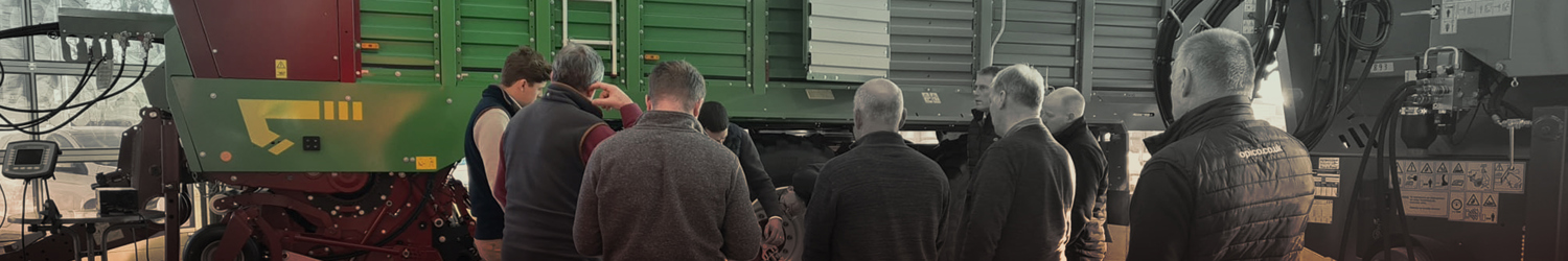 Customers stood in front of a Strautmann Forage Wagon